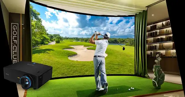 A backview of a person hitting the golf ball in front of a D k golf simulator projector