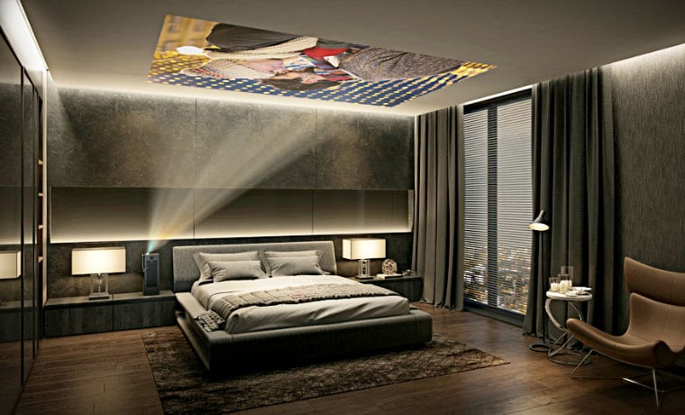 A view of a bedroom with a ceiling projector on