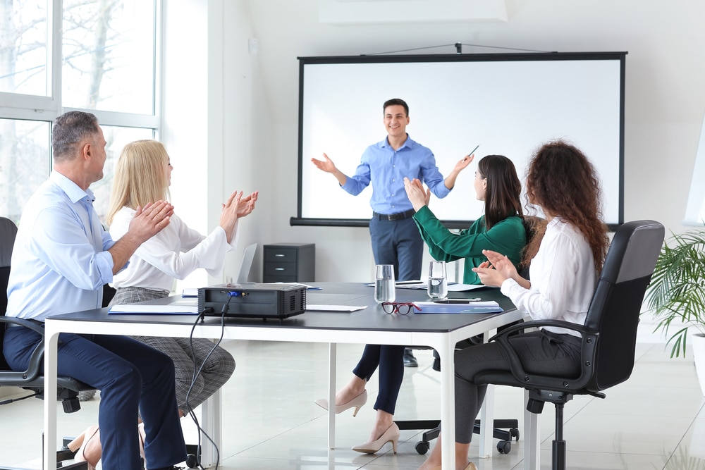 Businessman Giving Presentation During Meeting In Office