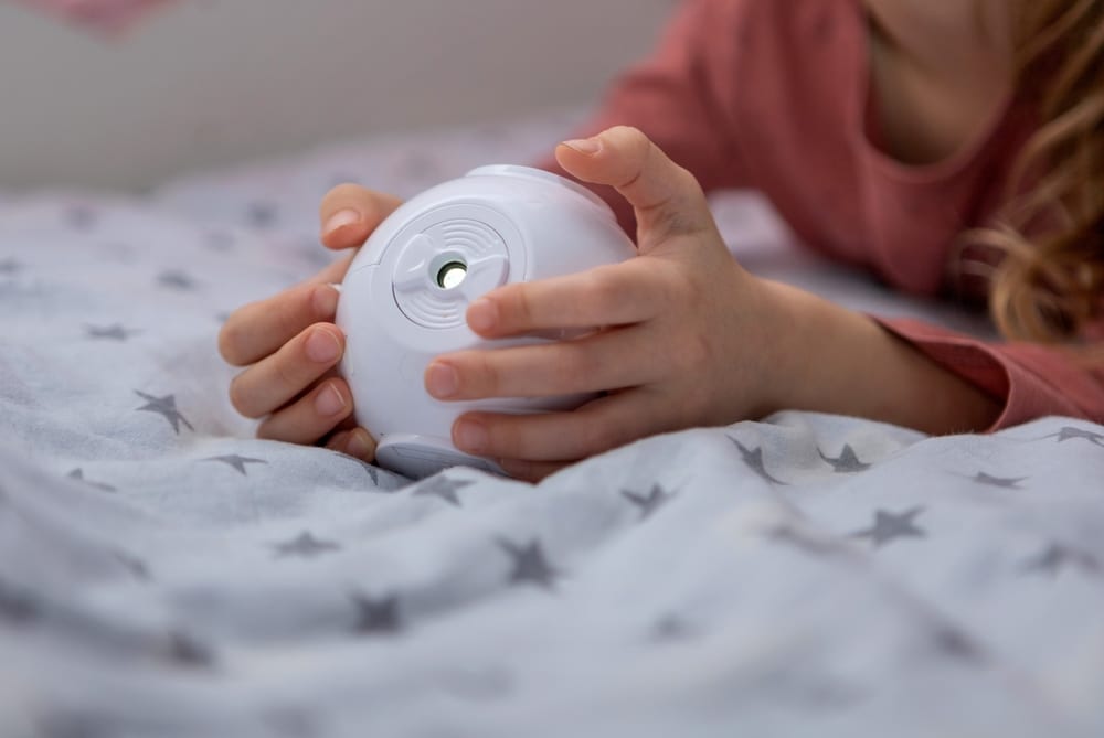 A view of a person holding a projector in hand