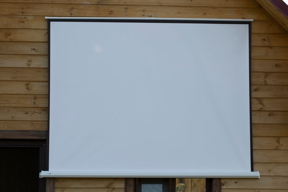 A view of a white projector with a wooden board background