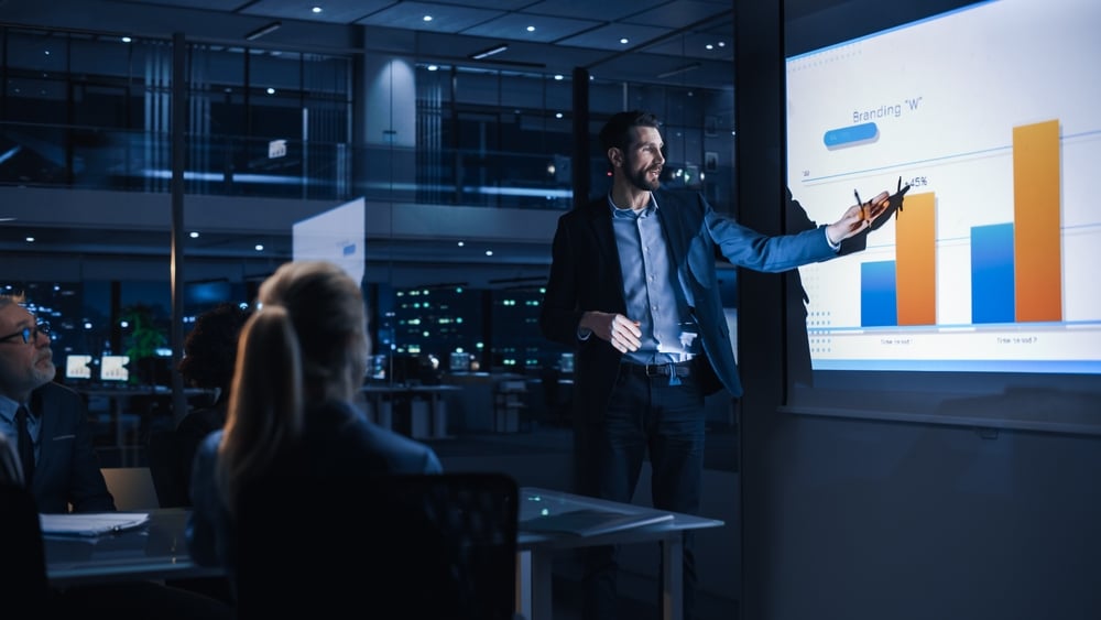 A view of a person giving presentation on a projector screen