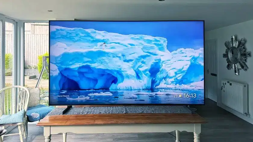 Large curved TV displaying an image of icy blue glaciers in a modern living room