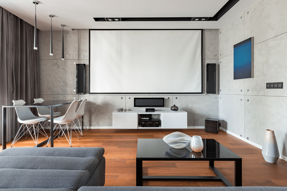 A front view of a white projector screen in a living room