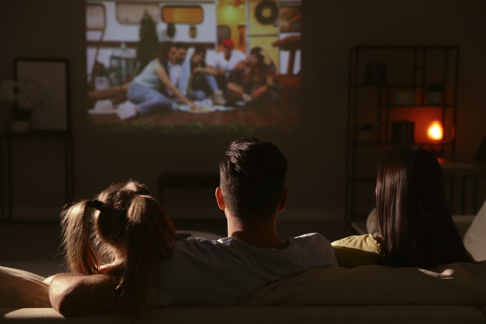 A view of a family watching images on a projector