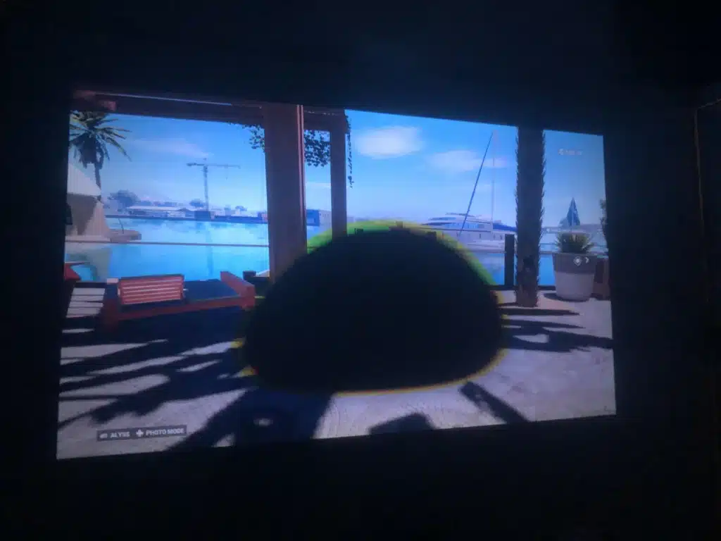 Projector screen showing a dark shadowy spot affecting the image quality in the center