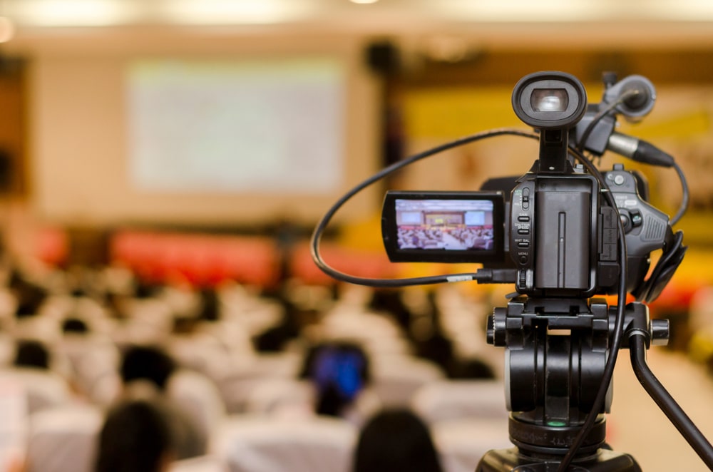 A view of a camcorder capturing a projector screen