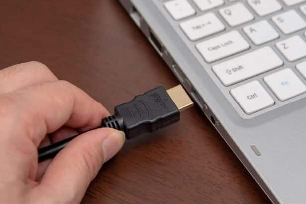 A view of an HMDI cable being inserted a laptop port