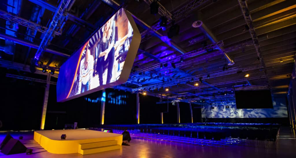 A view of an event with a grand projector on