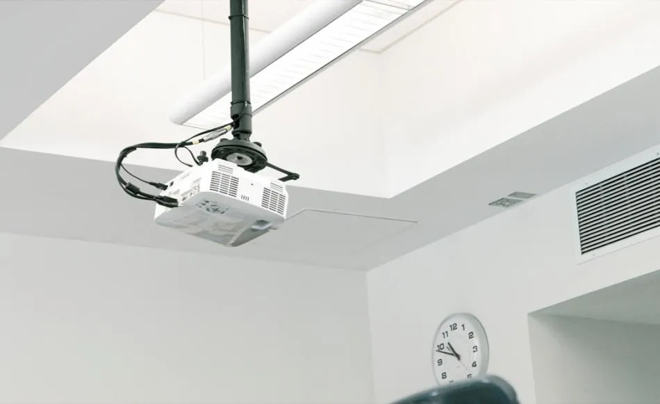 Ceiling mounted projector with cables neatly arranged showcasing a clean and space saving setup